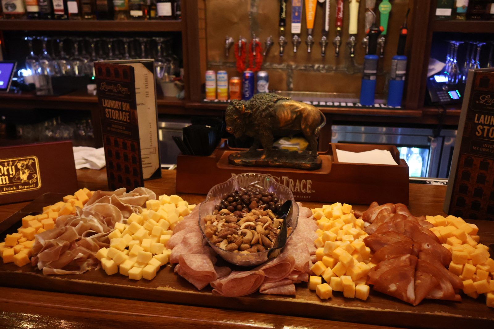 Charcuterie board and Laundry Bin Storage cards on the bar at The Laundry Room